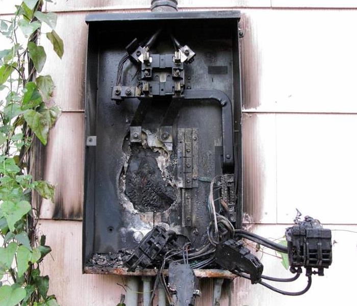 Electrical breaker box fire caused by overloaded electrical system