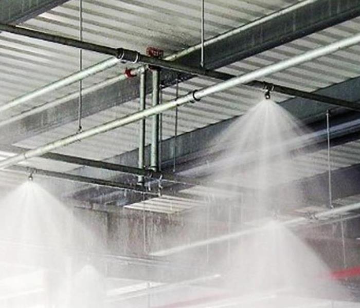 Fire sprinkler system activated, spraying 13 gallons of water per minute